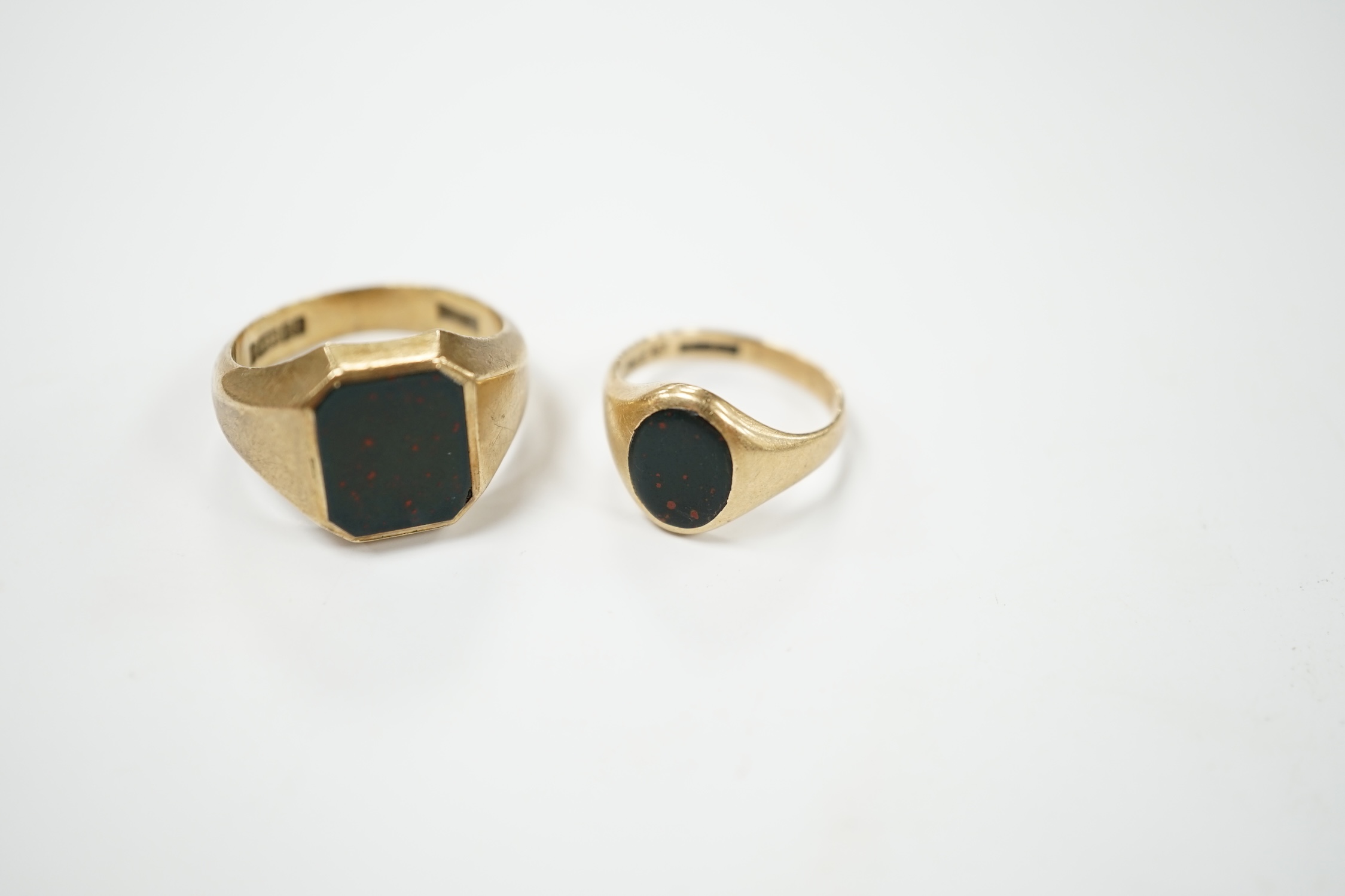 Two 9ct gold and bloodstone set signet rings, largest size Q, gross weight 11.5 grams. Condition - poor to fair